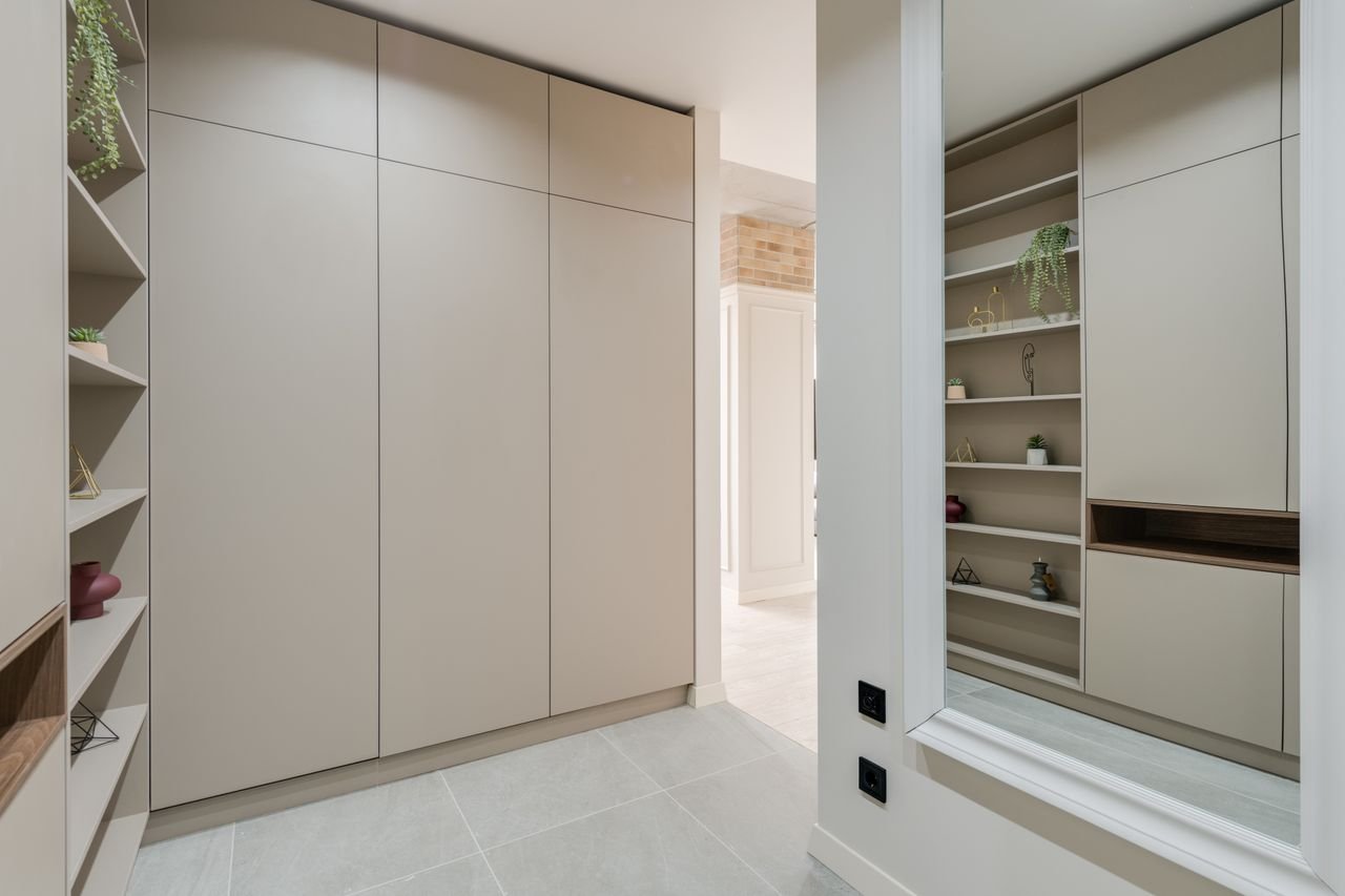 services-01 Explore this sleek and modern corridor featuring minimalist design with built-in wardrobes and stylish shelves.